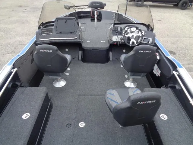 Slide: The Image of 2024 Nitro ZV20 boat interior with windshield and seating, parked on snowy ground. - 6