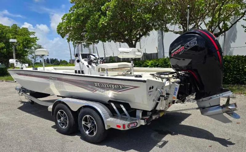 Slide: The Image of 2024 Ranger RB200 boat on trailer with powerful outboard motor, parked outdoors. - 5
