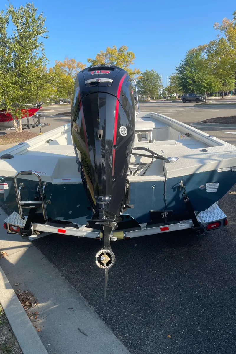 Slide: The Image of 2024 Ranger RB200 boat on trailer, parked outdoors, with outboard motor. - 4