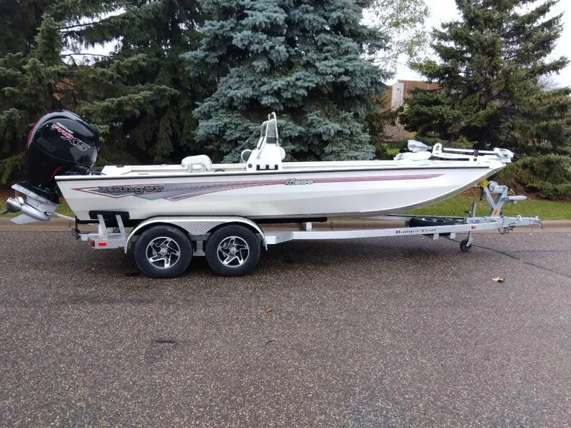 The Image of 2024 Ranger RB200 boat on trailer, parked on road with trees in background. - 0