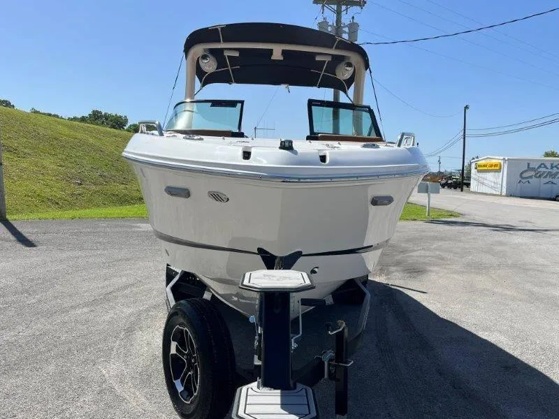 Slide: The Image of 2024 Chaparral 267 SSX boat on trailer, front view, outdoors. - 13