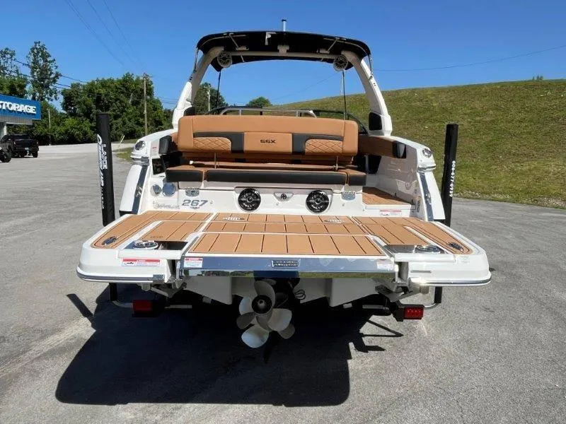 Slide: The Image of 2024 Chaparral 267 SSX boat rear view with teak swim platform. - 19