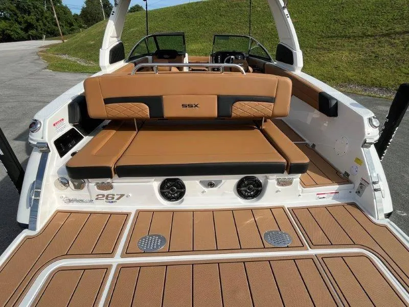 Slide: The Image of 2024 Chaparral 267 SSX boat with tan seating and sleek deck design. - 28