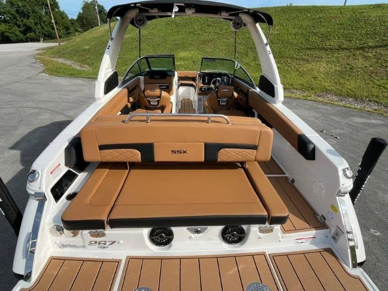 Slide: The Image of 2024 Chaparral 267 SSX boat interior with tan leather seating and modern design. - 30