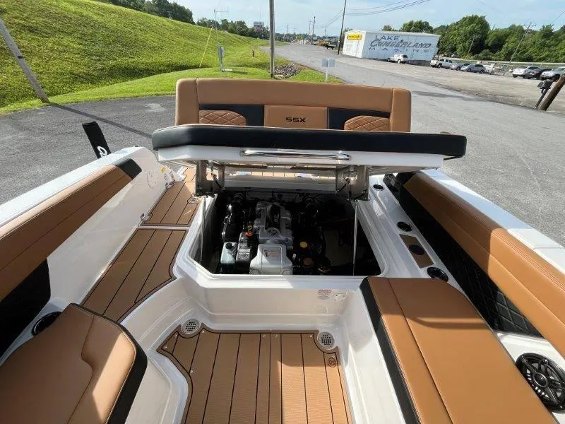 Slide: The Image of 2024 Chaparral 267 SSX boat with open engine compartment, tan seating, and teak flooring. - 33