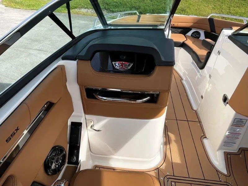 Slide: The Image of 2024 Chaparral 267 SSX boat interior with tan leather seats and sleek design. - 34