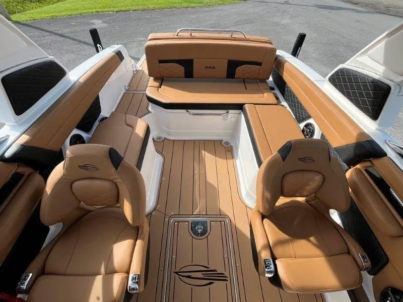 Slide: The Image of 2024 Chaparral 267 SSX boat interior with tan leather seating and wood-style flooring. - 35