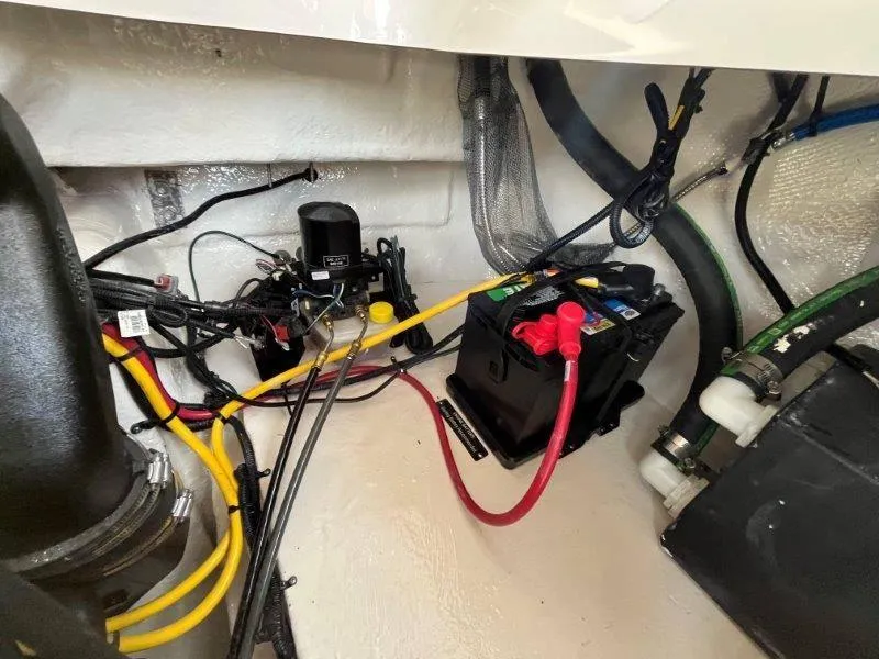 Slide: The Image of 2024 Chaparral 267 SSX engine compartment with battery and wiring. - 43