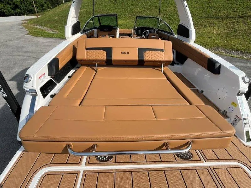 Slide: The Image of 2024 Chaparral 267 SSX boat with tan leather seating and spacious deck. - 44