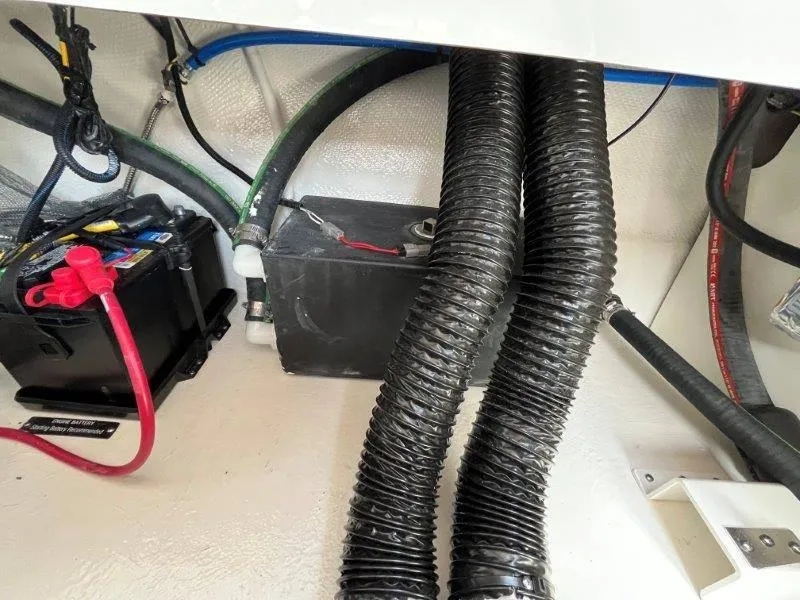 Slide: The Image of 2024 Chaparral 267 SSX engine compartment with battery and wiring. - 45