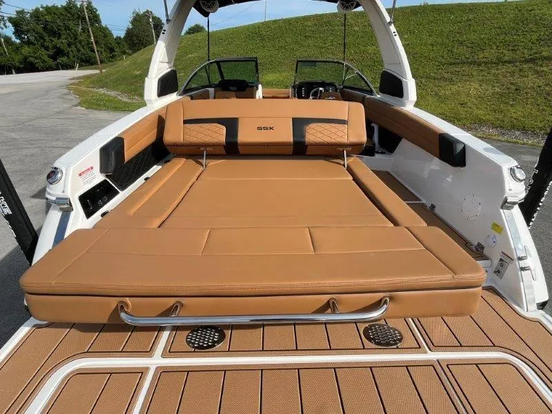 Slide: The Image of 2024 Chaparral 267 SSX boat with luxurious tan seating and sleek design. - 48
