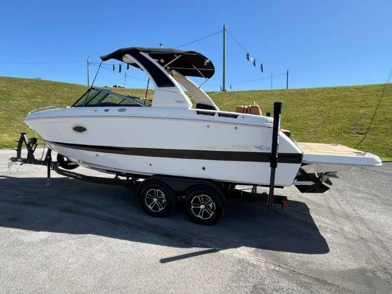 Slide: The Image of 2024 Chaparral 267 SSX boat on trailer under clear blue sky. - 9