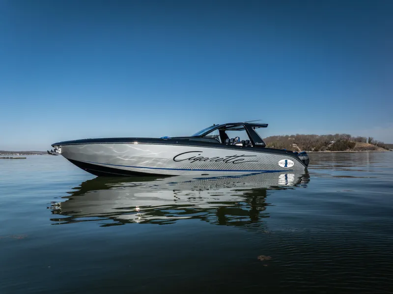 Slide: The Image of 2025 Cigarette 42 Auroris boat on calm water under clear blue sky. - 1