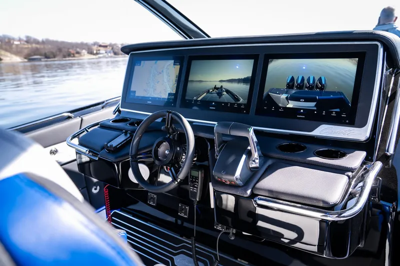 Slide: The Image of 2025 Cigarette 42 Auroris boat cockpit with advanced navigation screens and controls. - 12
