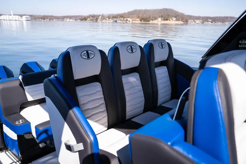 Slide: The Image of 2025 Cigarette 42 Auroris boat interior with blue and white seating on a calm lake. - 16