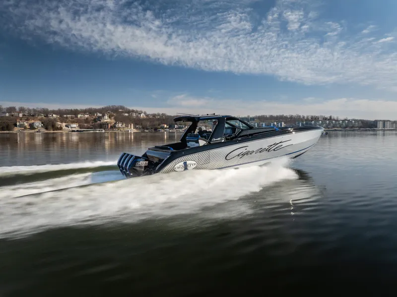 Slide: The Image of 2025 Cigarette 42 Auroris speedboat cruising on a calm lake under a clear sky. - 18