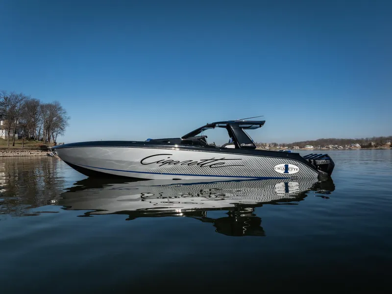The Image of 2025 Cigarette 42 Auroris boat on calm water under clear blue sky. - 2