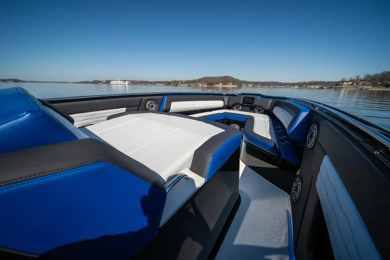Slide: The Image of 2025 Cigarette 42 Auroris boat interior with blue and white seating on a calm lake. - 27