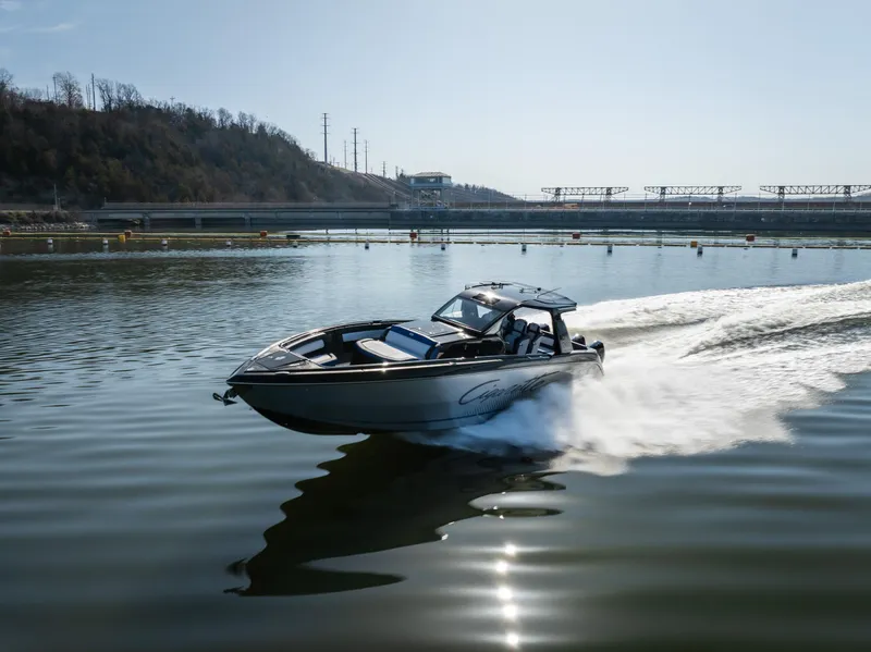 Slide: The Image of 2025 Cigarette 42 Auroris speedboat cruising on a calm lake under clear skies. - 30