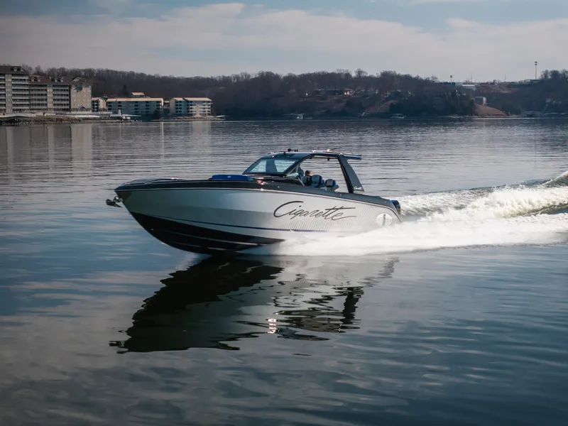 Slide: The Image of 2025 Cigarette 42 Auroris speedboat cruising on a calm lake with distant shoreline. - 32