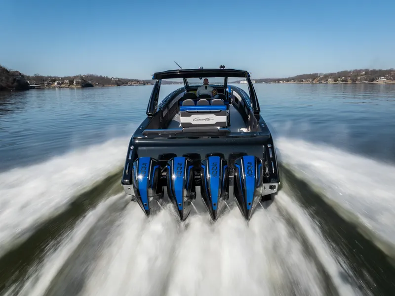 Slide: The Image of 2025 Cigarette 42 Auroris speedboat with multiple engines cruising on a calm lake. - 33