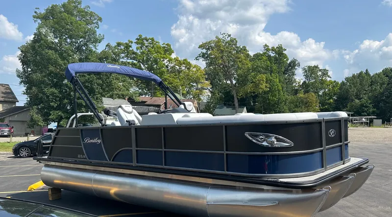 Slide: The Image of 2025 Bentley Pontoons Elite 223 Swingback Dual Capt. on trailer, parked outdoors. - 0