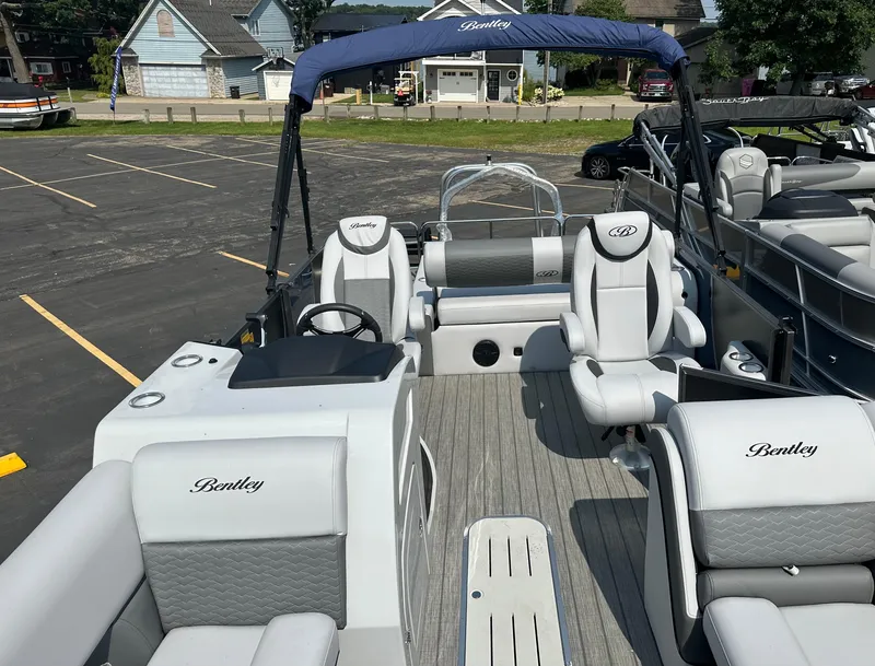 Slide: The Image of 2025 Bentley Pontoons Elite 223 Swingback Dual Capt. with luxurious seating and sleek design. - 14