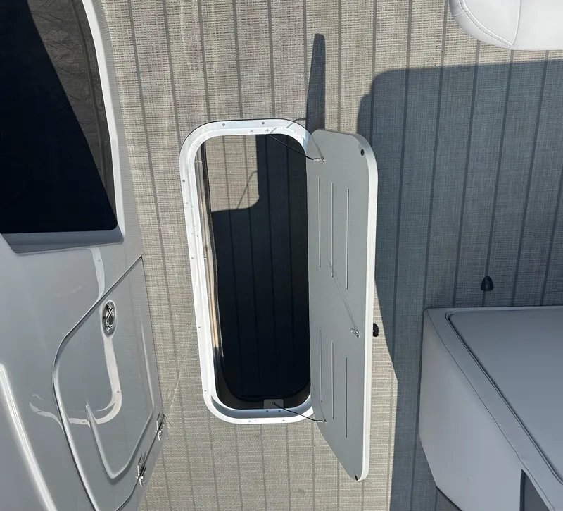 Slide: The Image of 2025 Bentley Pontoons Elite 223 Swingback Dual Capt. deck with open hatch. - 16