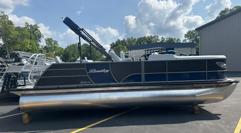 Slide: The Image of 2025 Bentley Pontoons Elite 223 Swingback Dual Capt. on display outdoors. - 2