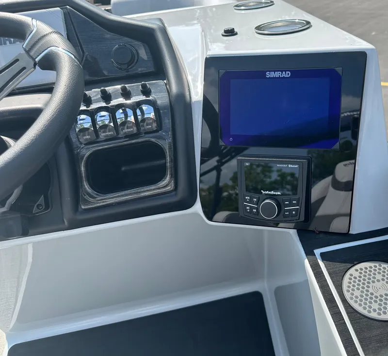 Slide: The Image of 2025 Bentley Pontoons Elite 223 dashboard with Simrad display and controls. - 6