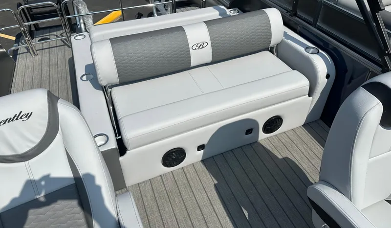 Slide: The Image of 2025 Bentley Pontoons Elite 223 Swingback Dual Capt. interior with luxurious seating and speakers. - 9