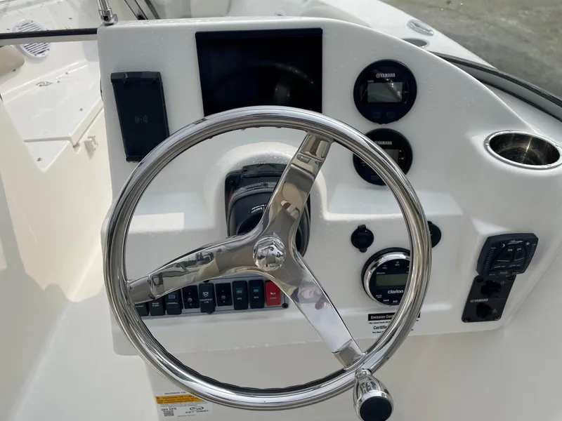 Slide: The Image of 2025 Key West 203 DFS boat dashboard with steering wheel and control panel. - 4