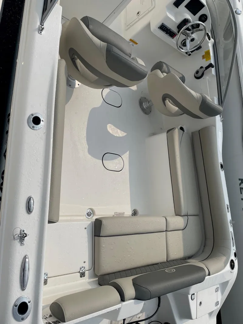 Slide: The Image of 2025 Key West 203 DFS boat interior with gray seating and steering console. - 7