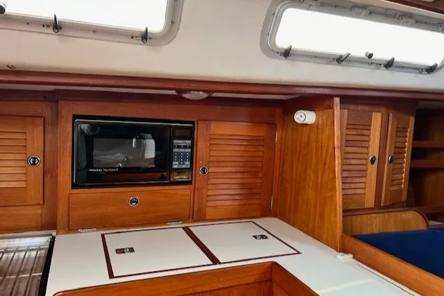 Slide: The Image of Interior of 1994 J Boats J 44 sailboat with wooden cabinetry and built-in microwave. - 15