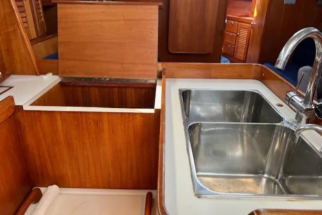 Slide: The Image of Interior of 1994 J Boats J 44 yacht featuring a wooden kitchen with a double sink. - 20