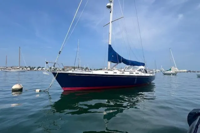 Slide: The Image of Sailboat J Boats J 44, 1994 model, anchored in calm waters under a clear blue sky. - 3
