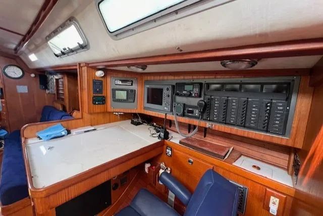 Slide: The Image of Navigation station inside 1994 J Boats J 44 yacht with control panels and seating. - 9