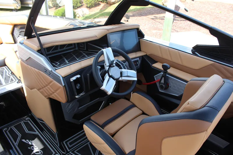 Slide: The Image of 2024 Tigé Ultré 23ZX boat interior with modern dashboard and tan seating. - 10