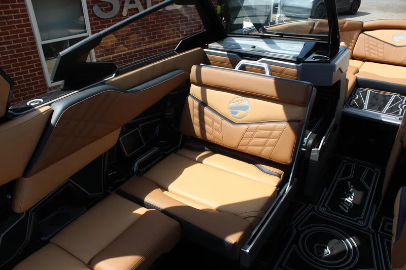 Slide: The Image of 2024 Tigé Ultré 23ZX boat interior with luxurious tan leather seating and modern design. - 11