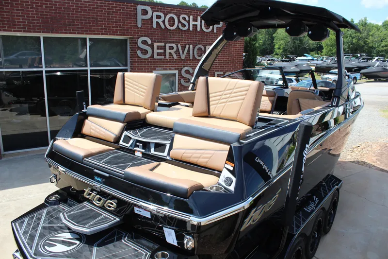 Slide: The Image of 2024 Tigé Ultré 23ZX boat with luxurious seating, displayed at a pro shop. - 6
