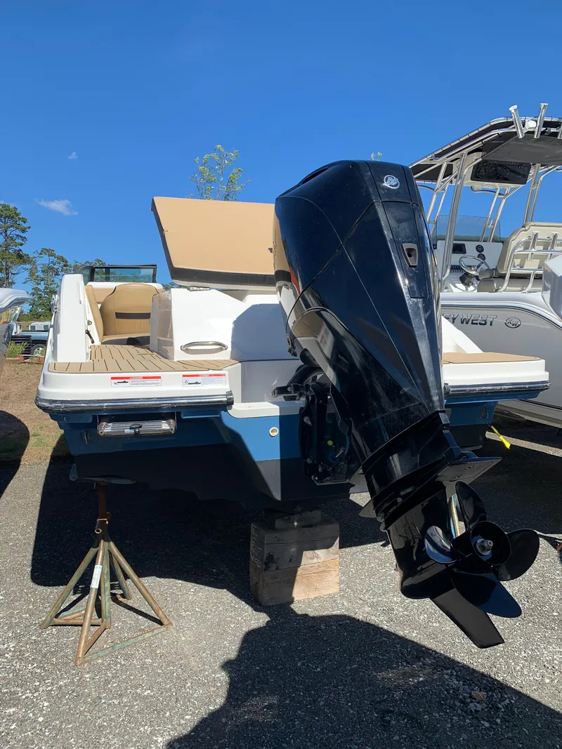 Slide: The Image of 2022 Sea Ray SPX 230 OB boat with outboard motor, displayed outdoors. - 2