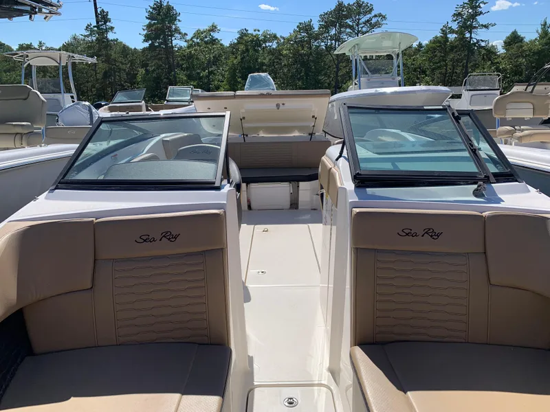 Slide: The Image of 2022 Sea Ray SPX 230 OB boat interior with tan seating and dual windshields. - 8