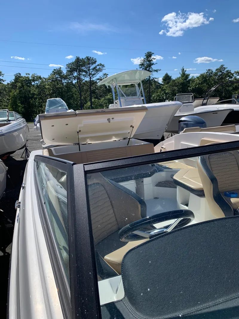 Slide: The Image of 2022 Sea Ray SPX 230 OB boat in a sunny outdoor showroom. - 9
