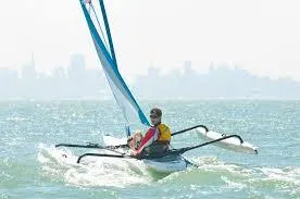 Slide: The Image of Sailor navigating a 2025 Hobie Tandem Island kayak on open water. - 0