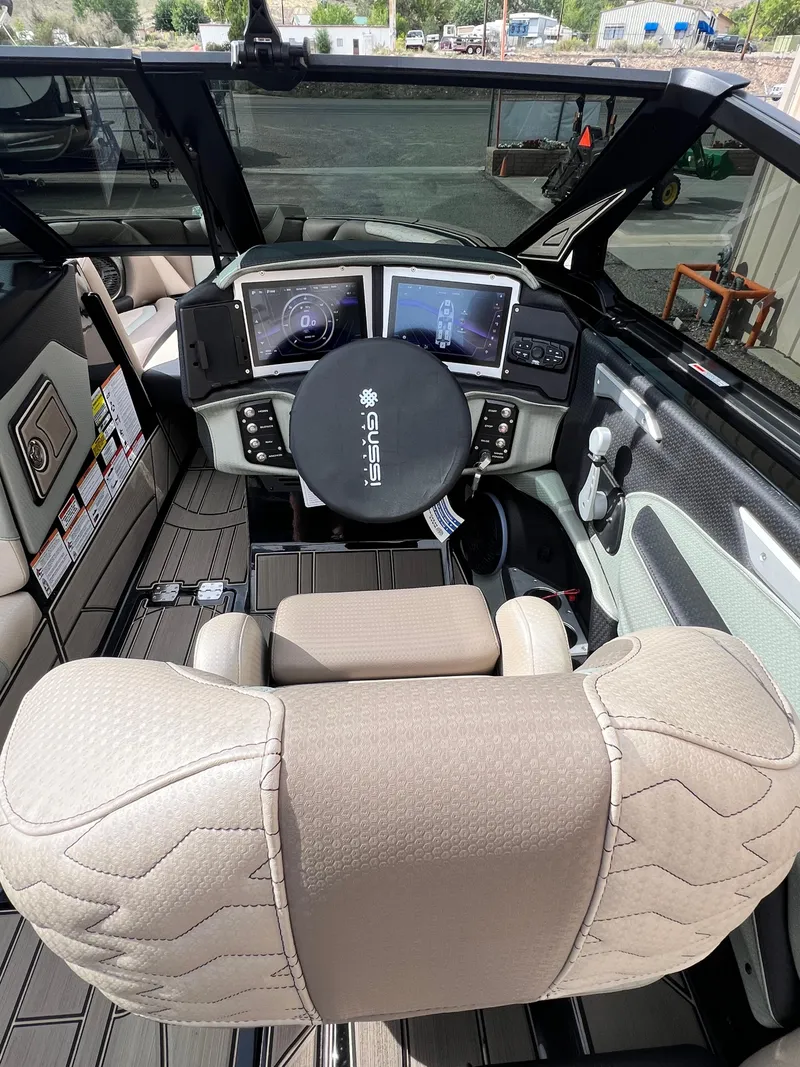 Slide: The Image of 2024 Centurion Ri230 boat interior with modern dashboard and steering wheel. - 14