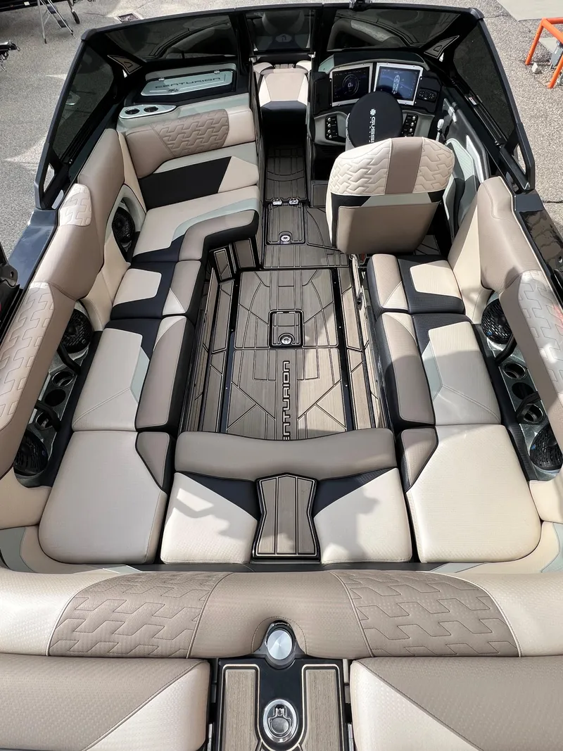 Slide: The Image of 2024 Centurion Ri230 boat interior with luxurious seating and modern dashboard. - 15
