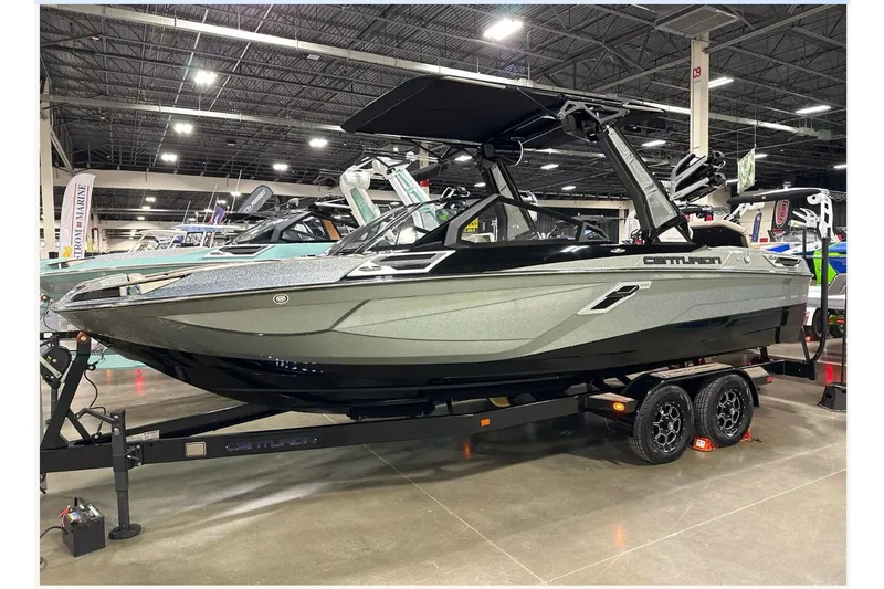Slide: The Image of 2024 Centurion Ri230 boat on display in a showroom. - 5