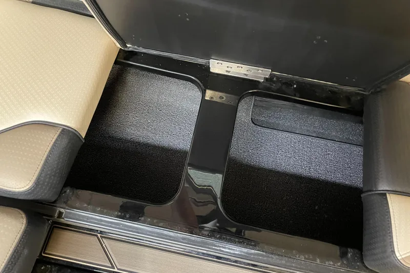 Slide: The Image of 2024 Centurion Ri230 interior storage compartments with beige and black seating. - 8