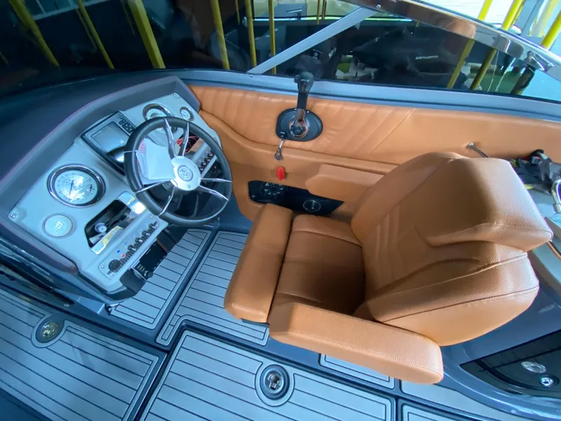 Slide: The Image of 2017 Cruisers Sport Series 298 SS South Beach Edition cockpit with tan leather seat and controls. - 17