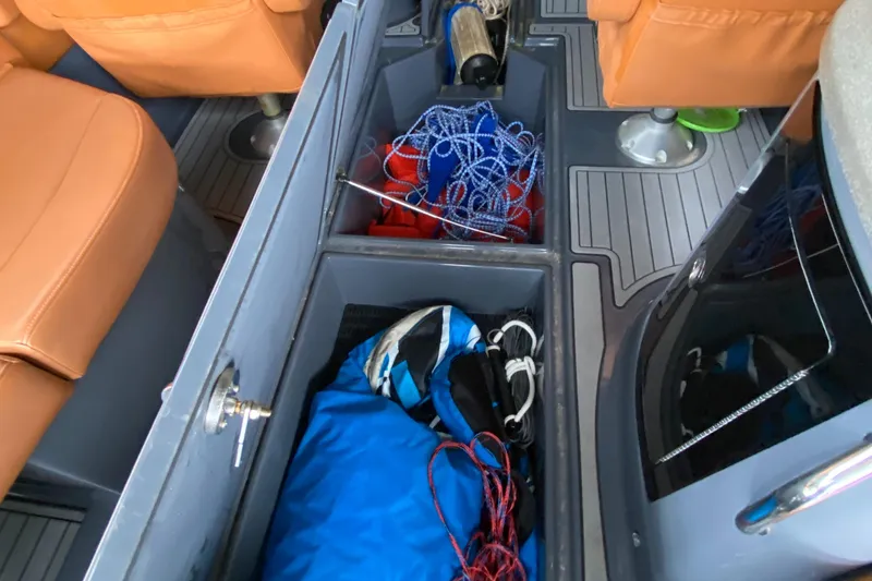 Slide: The Image of 2017 Cruisers Sport Series 298 SS boat interior storage with gear and equipment. - 26